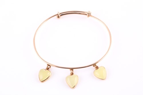 Lot 153 - A triple chrysoprase heart bangle, set with...