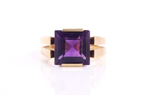 Lot 291 - A square amethyst dress ring, set with a...