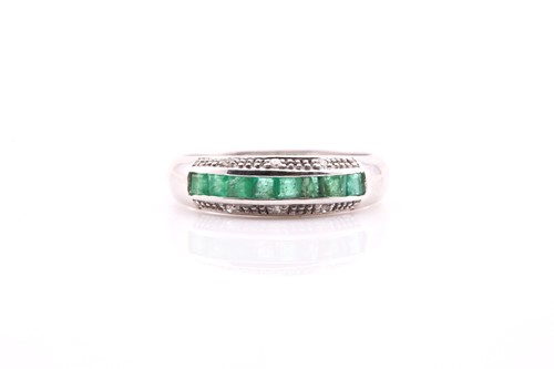 Lot 148 - An emerald and diamond half hoop eternity ring;...