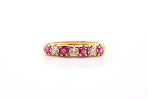Lot 538 - A ruby and diamond seven stone half hoop ring;...