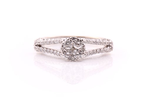 Lot 26 - A diamond cluster ring; the central circular...