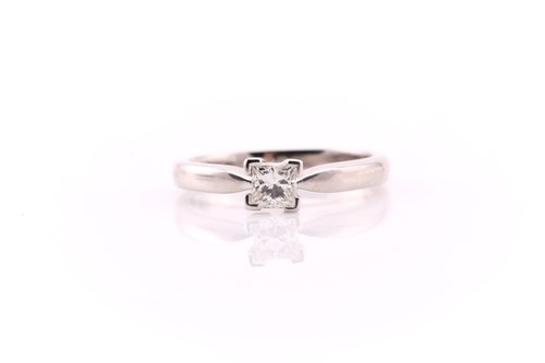 Lot 805 - A single stone diamond ring; the princess cut...