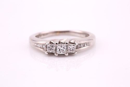 Lot 151 - A three stone half hoop daimond ring; the...