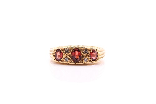 Lot 392 - A seven-stone garnet and diamond half hoop...