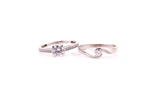 Lot 379 - A single stone diamond cross-over ring, the...