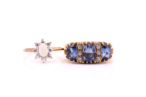Lot 754 - A three stone half hoop oval sapphire ring;...