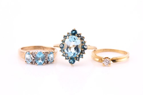 Lot 358 - A three stone half hoop blue topaz and diamond...