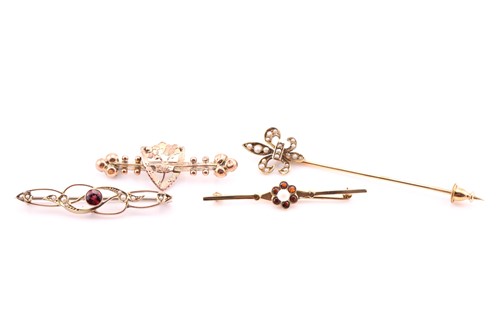 Lot 677 - A fleur de lys stick pin, set with seed pearls...