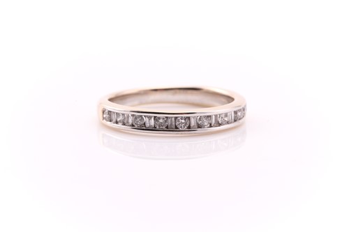Lot 605 - A diamond half hoop eternity ring; alternately...