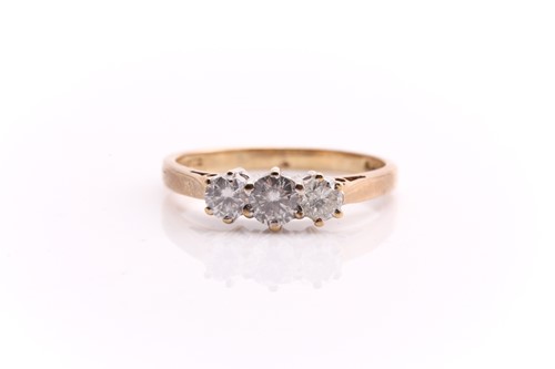 Lot 54 - A three stone half hoop diamond ring; the...