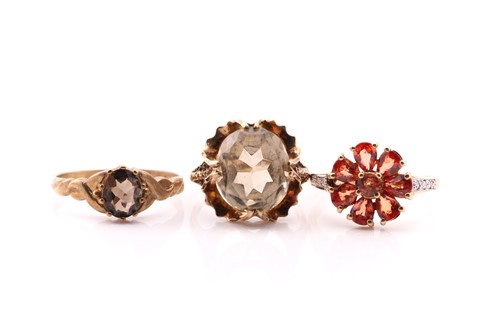 Lot 672 - An orange sapphire and diamond flower-shaped...