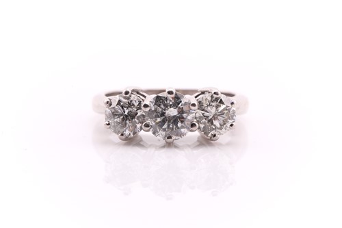 Lot 117 - A three stone half hoop diamond ring; the...