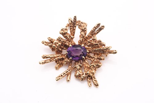 Lot 97 - An amethyst abstract brooch, 1970s, the...