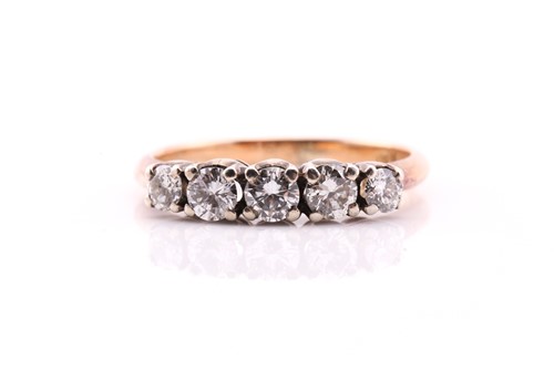 Lot 64 - A five stone diamond ring, on yellow metal...