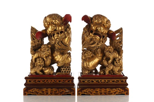 Lot 121 - A pair of Chinese carved and gilded wood...
