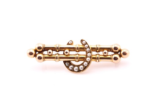 Lot 141 - A Victorian gold bar brooch the central...