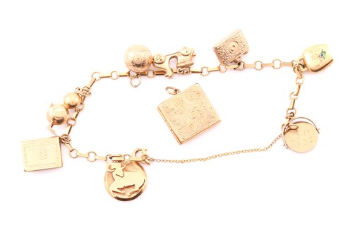 Lot 243 - A Continental yellow precious metal charm...