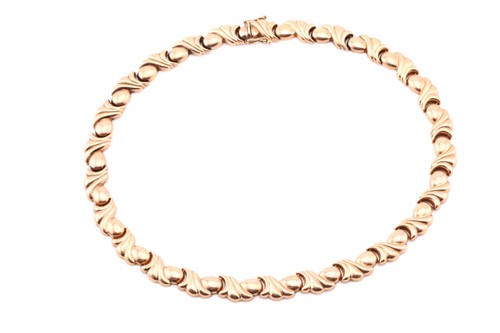 Lot 150 - A 9ct yellow gold reeded scroll and egg link...