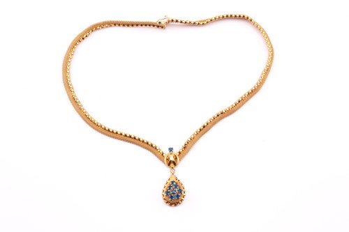 Lot 195 - A yellow metal and blue stone pendant and...
