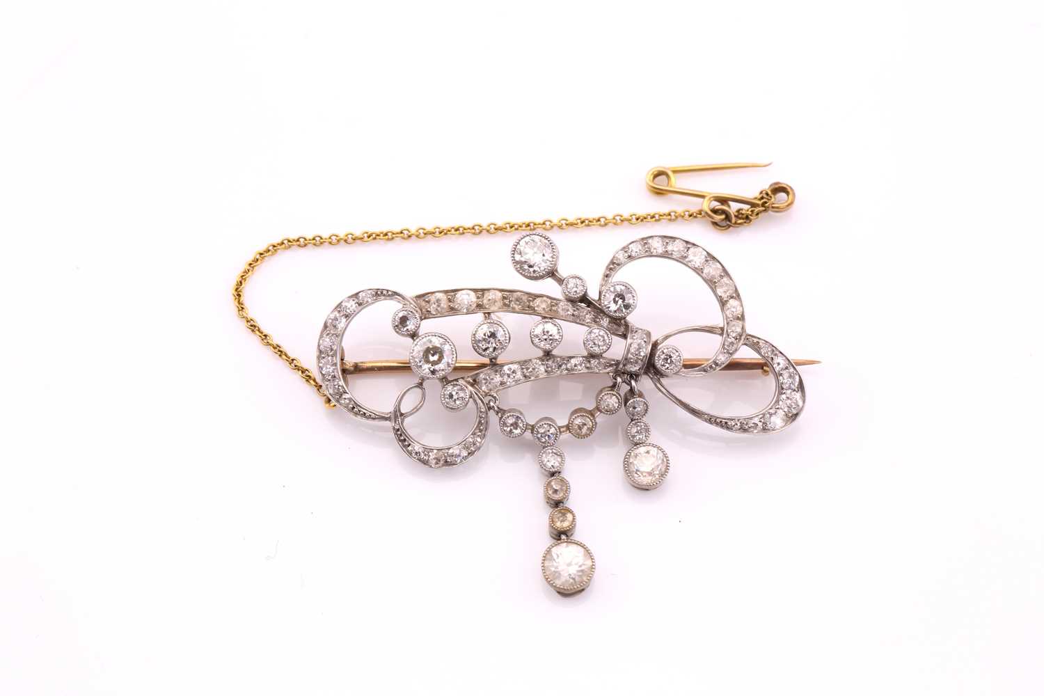 Lot 217 - An Edwardian diamond set scroll brooch,...