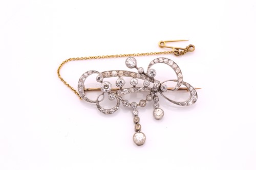Lot 217 - An Edwardian diamond set scroll brooch,...