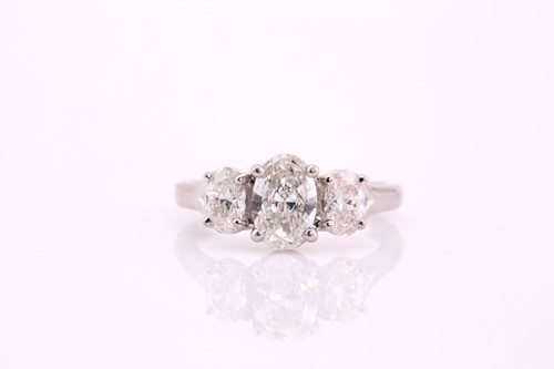 Lot 170 - An oval cut diamond three stone ring...