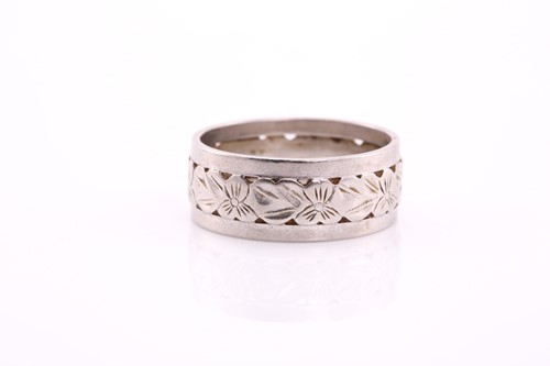 Lot 65 - A white precious metal wedding band, with...