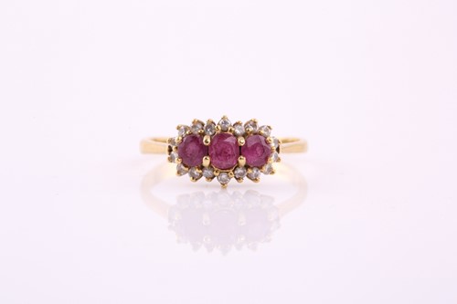 Lot 18 - A ruby and diamond ring; the three oval and...