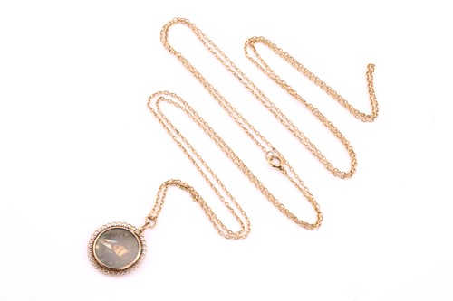 Lot 468 - A circular double sided locket pendant, with...