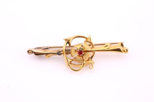Lot 21 - An Edwardian flowerhead bar brooch, red paste...