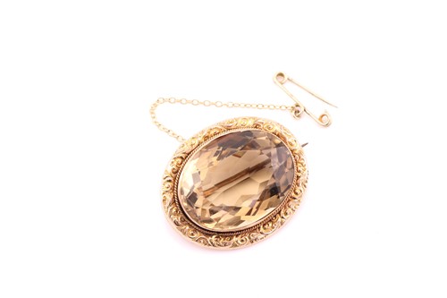 Lot 387 - An Edwardian smoky brown quartz oval brooch,...