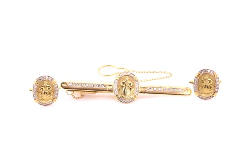 Lot 375 - A diamond and gold tie clip with chain and a...