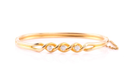 Lot 103 - A diamond set hinged bangle, consisting of...