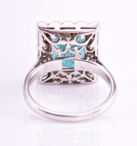 Lot 46 - An emerald and diamond halo ring, consisting...