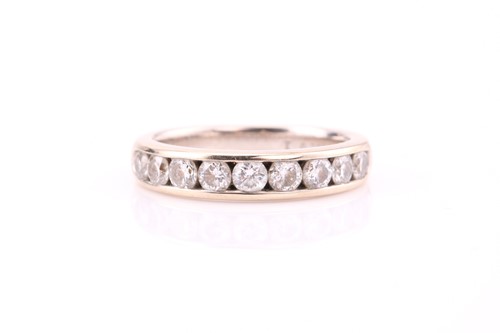 Lot 82 - A half hoop diamond ring; the nine round...