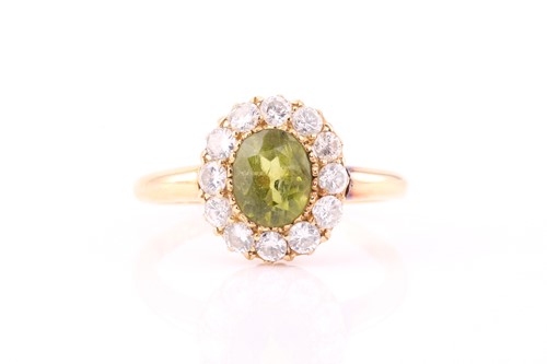 Lot 477 - An 18ct gold peridot and diamond entourage...