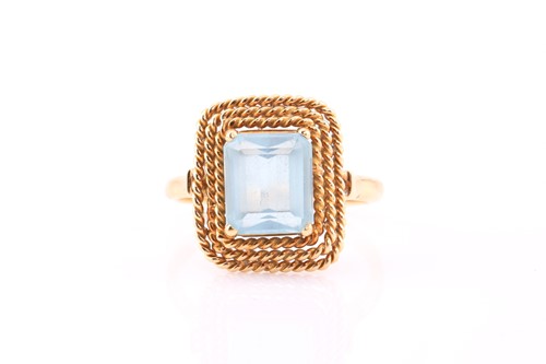 Lot 386 - An aquamarine dress ring, consisting of an...