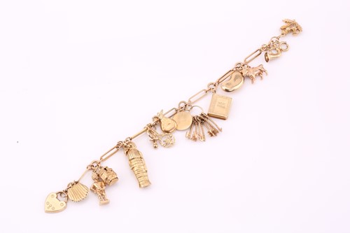 Lot 405 - A 9ct yellow gold charm bracelet, consisting...