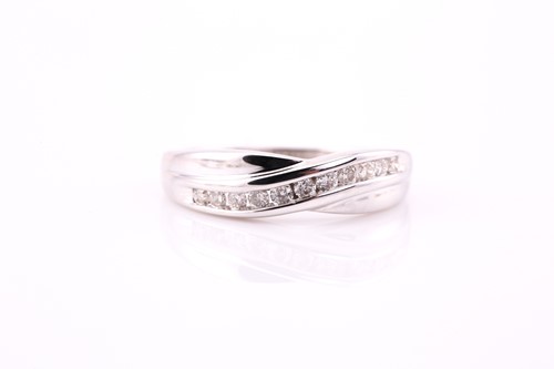 Lot 59 - A crossover half eternity ring, consisting of...