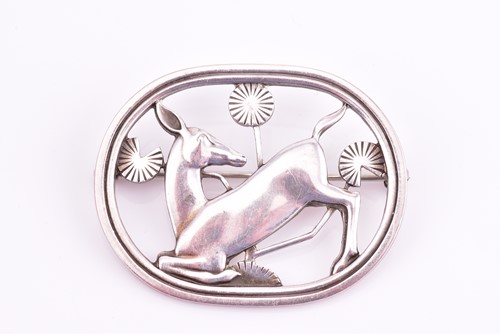 Lot 14 - Georg Jensen - a brooch depicting kneeling...