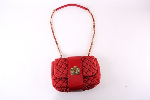 Lot 451 - A Moschino red quilted handbag with gilt...