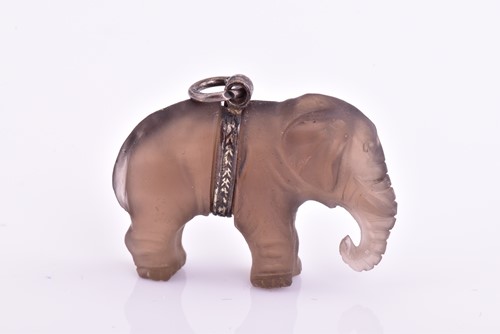 Lot 407 - A smoky glass elephant pendant, with a white...