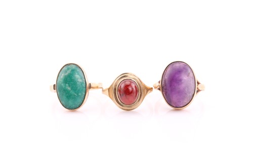 Lot 85 - Three cabochons set dress rings, the first...