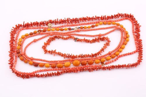 Lot 58 - A coral bead two strand necklace, the yellow...