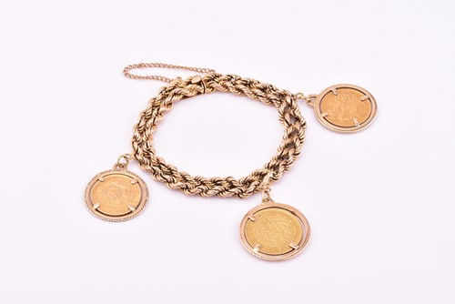 Lot 81 - A yellow metal double rope twist bracelet...