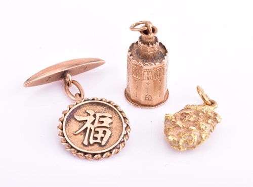 Lot 47 - A nugget pendant, a yellow metal charm and a...