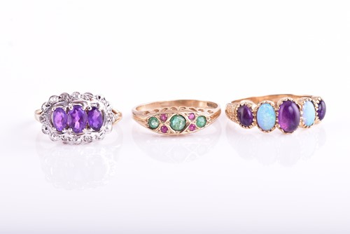 Lot 411 - A five stone half hoop opal and amethyst ring...