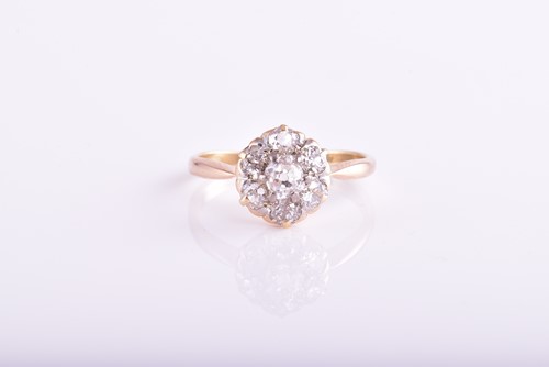 Lot 436 - A seven stone diamond cluster ring; the mixed...