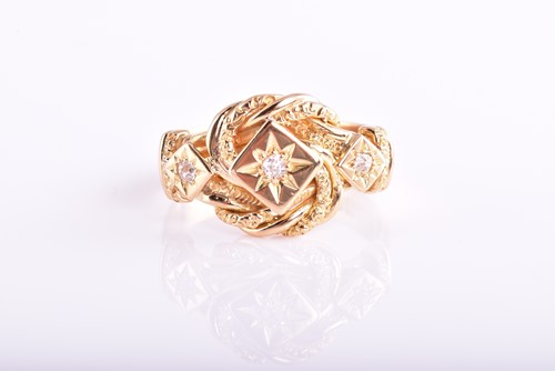 Lot 409 - A three stone diamond ring; the gypsy set,...