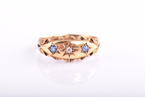 Lot 165 - An Edwardian three stone sapphire and diamond...